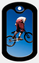 Lenticular print dog tag with BMx x-Games cyclist does a trick jump off a halfpipe, flip